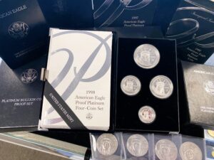 A group of silver coins in a plastic container.