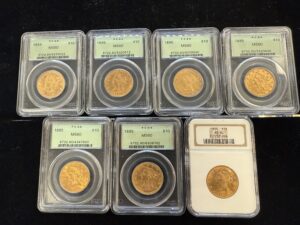 A group of silver coins in a plastic container.