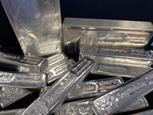 A group of silver coins in a plastic container.