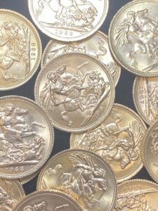 A group of silver coins in a plastic container.