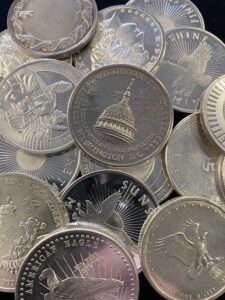A pile of silver coins with various denominations.