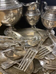 A group of silver coins in a plastic container.
